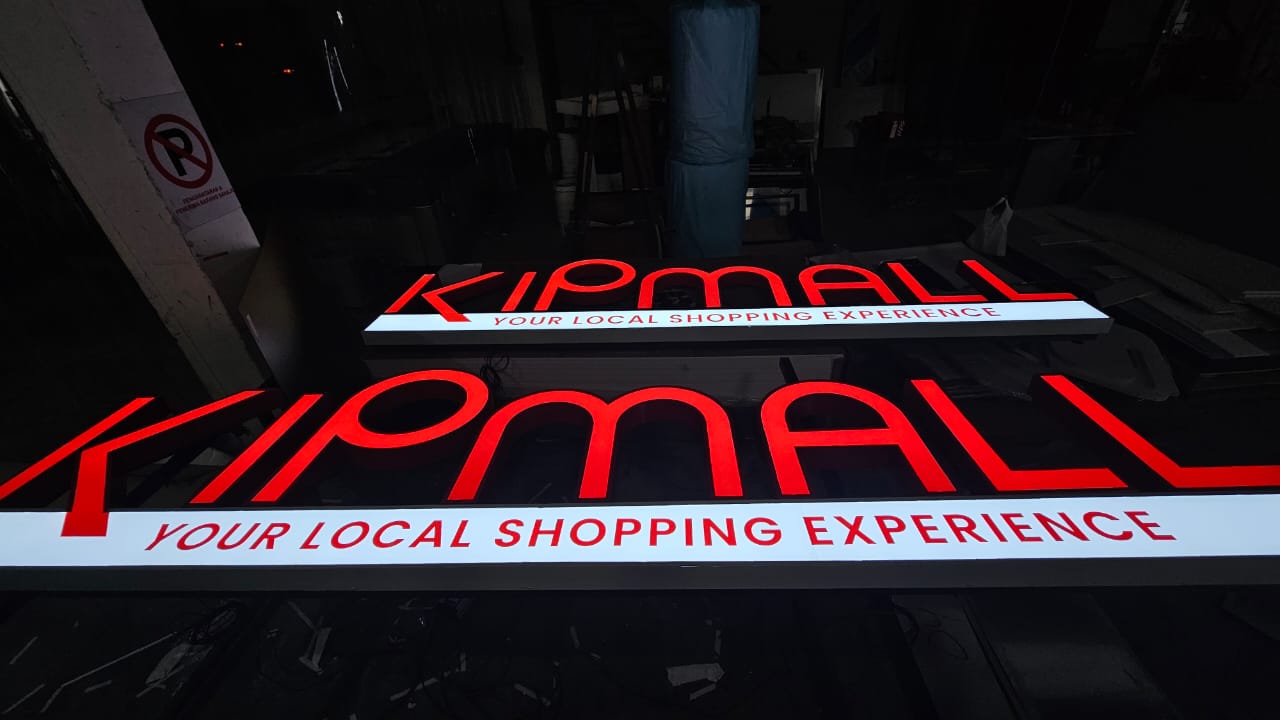 KIPMALL frontlit illuminated channel letter signboard glowing red at night